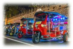 A group of tuk parked on a streetDescription automatically generated